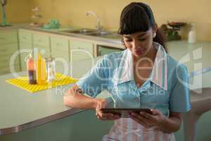 Waitress using digital tablet in restaurant