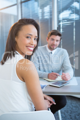 Portrait of female executive sitting at desk
