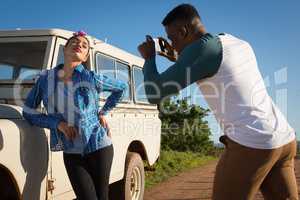 Man clicking picture of woman with mobile phone