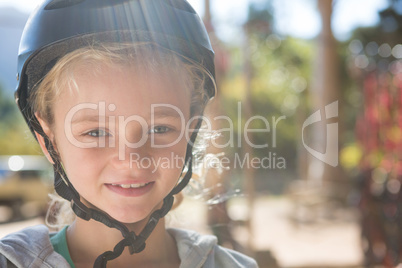 Little girl wearing helmet in the forest