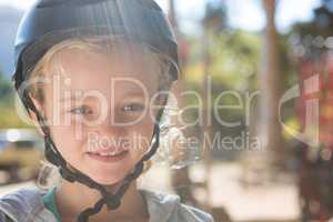 Little girl wearing helmet in the forest