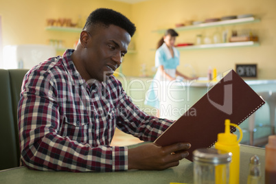 Man looking at menu in restaurant