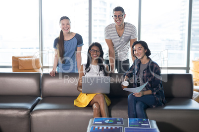 Smiling executives working together in office