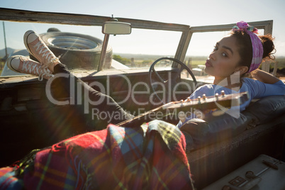 Woman sitting in car on a sunny day