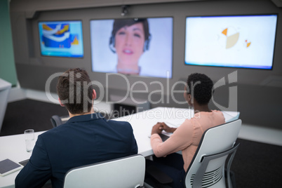 Male and female executives having video call