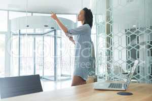 Female executive using invisible digital screen