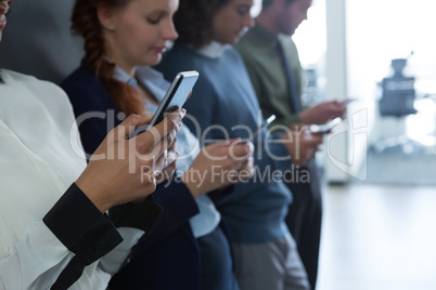 Team of business people using mobile phone