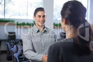 Male executive shaking hands with woman