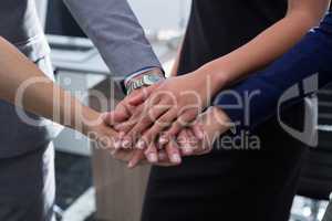 Group of executives stacking hands over each other