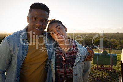 Portrait of couple standing together at countryside