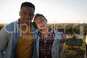 Portrait of couple standing together at countryside