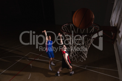 Two players playing basketball