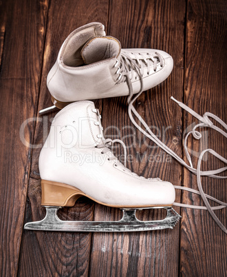 a pair of white leather female skates