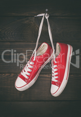 a pair of old red sneakers