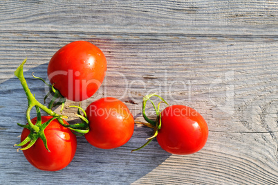 Red tomatoes on wooden surface. Flat lay,top view.