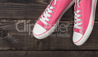 pair of pink textile shoes