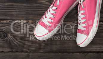pair of pink textile shoes