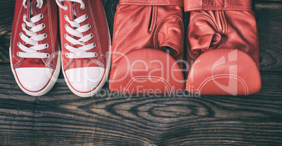 pair of red sneakers and red leather boxing gloves