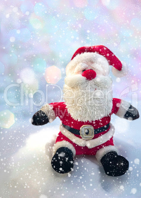Textile Santa Claus sitting on a snow bank