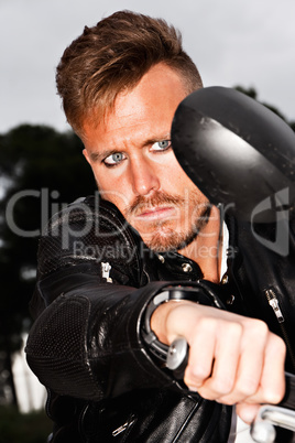 Fashionable young man in a motorbike.