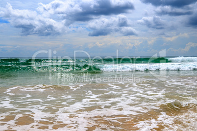 Sandy beach. Dramatic cloudscape with heavy rain and tropical st