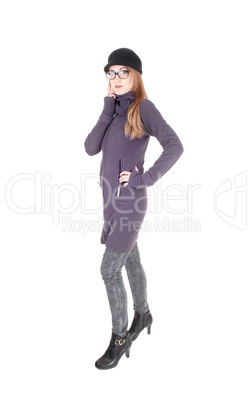Woman standing in winter coat hat and glasses