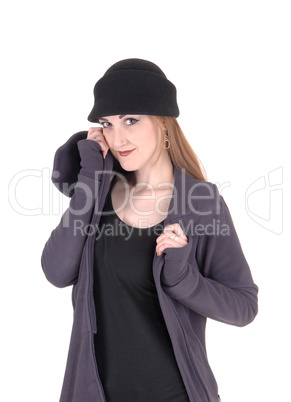 Young woman standing in winter coat and hat