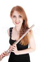 Woman standing, holding her flute and smiling