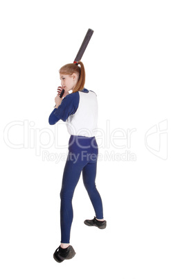 Woman swinging her bat in softball