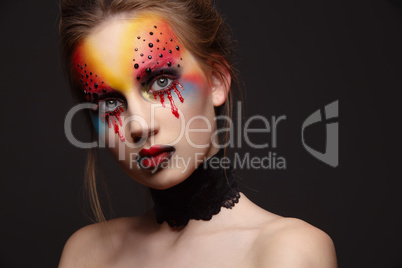 Young female model with bloody eyes makeup