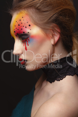 Young female model with bloody eyes makeup