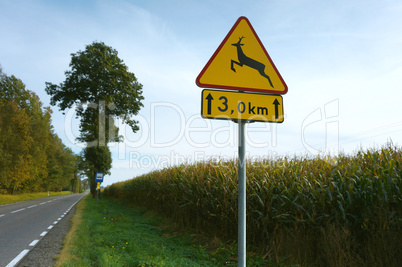 sign "beware of animals crossing traffic" road warning