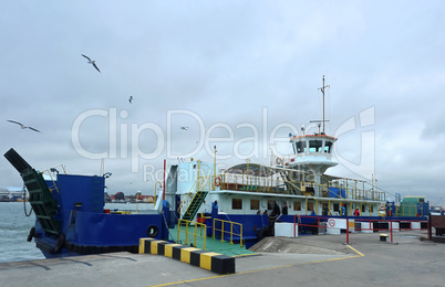 blue a passenger ferry at the dock, loading onto the ferry to cr