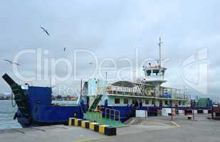 blue a passenger ferry at the dock, loading onto the ferry to cr