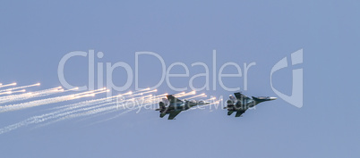 Two military aircrafts flying in the blue sky