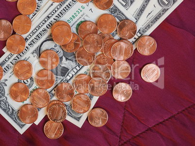 Dollar notes and coin, United States over red velvet background