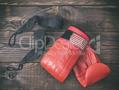 red leather boxing gloves and black bandage