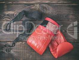 red leather boxing gloves and black bandage