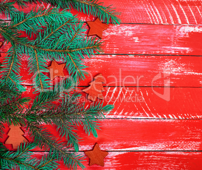 bright red wooden background of boards with green spruce branch