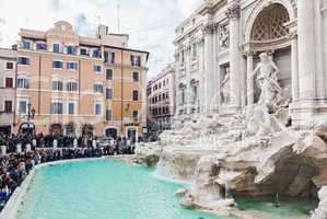 Famous Trevi fountain with tourist crowd in Rome