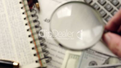 401k plan is watched with magnifier. Retirement concept. Selective focus.
