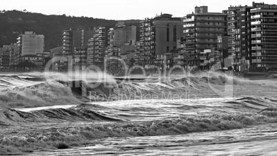 Beautiful sunset in Spain with big waves in black and white colo