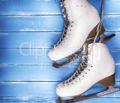 a pair of worn white leather skates for figure skating