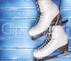 a pair of worn white leather skates for figure skating