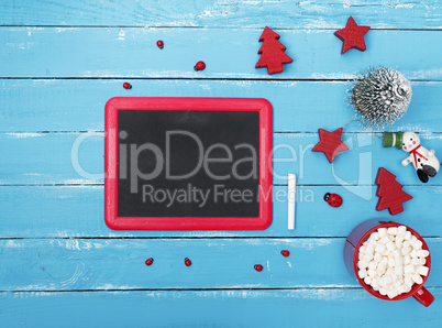 chalkboard in a red frame on a blue wooden background
