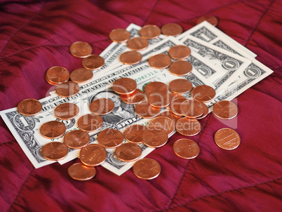 Dollar notes and coin, United States over red velvet background