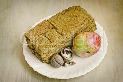 Cake , Apple and walnuts on the plate.