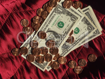 Dollar notes and coin, United States over red velvet background