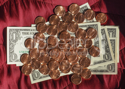 Dollar notes and coin, United States over red velvet background