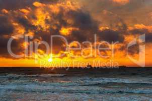 sunset on the sea, the waves beat against the breakwater, the sea at dawn, the ships on the horizon